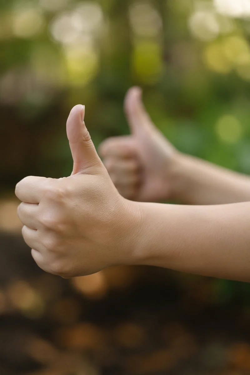 Friendly Hands Giving Thumbs Up Outdoors