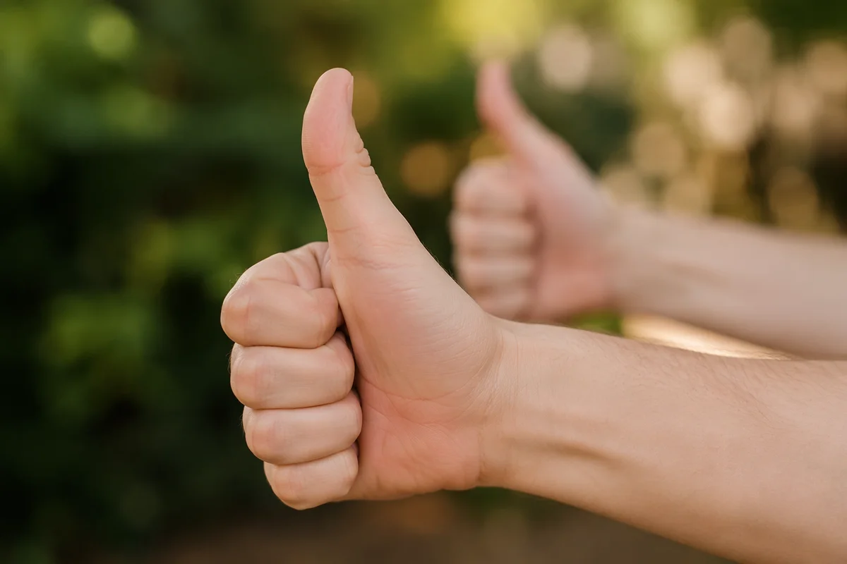 Encouraging Thumbs Up Hands Outdoors