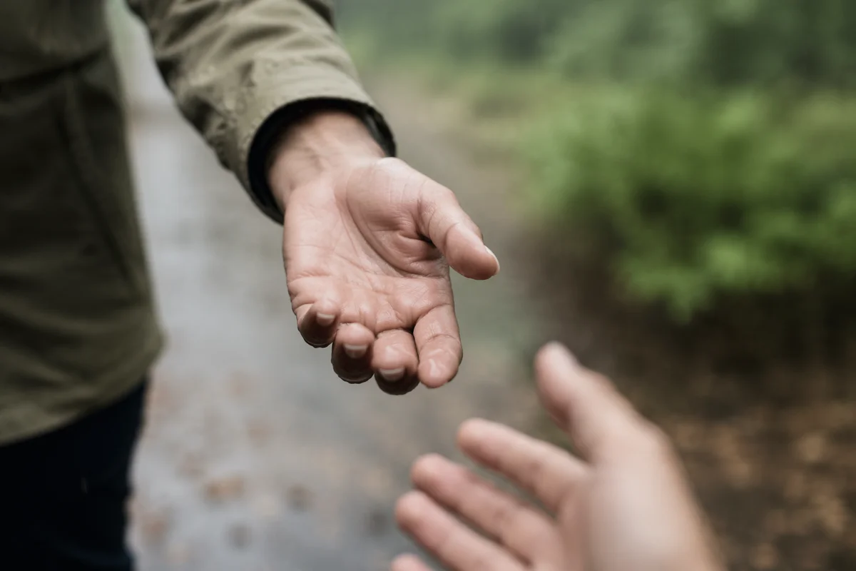 Helping Hand Reaching on Rainy Path