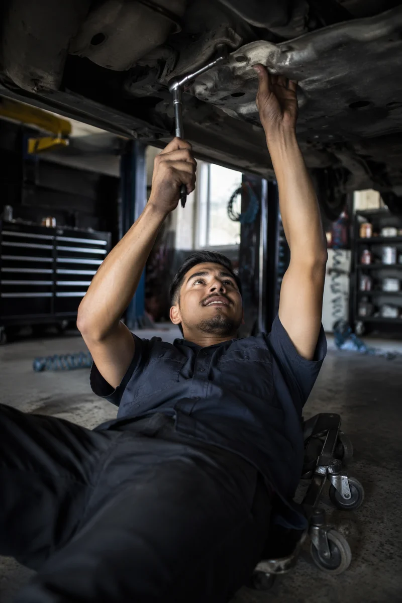 Mechanic Working Under Raised Car
