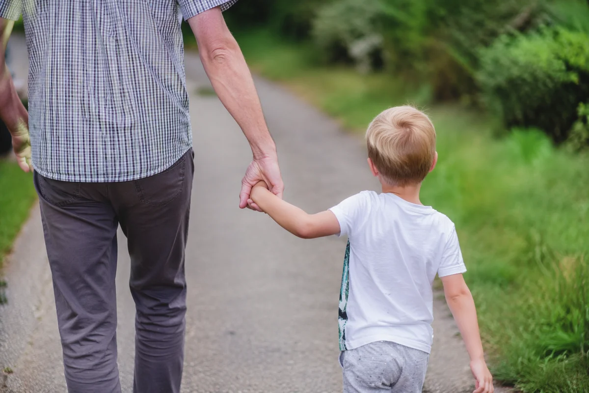 Parent and Child Walking Hand in Hand