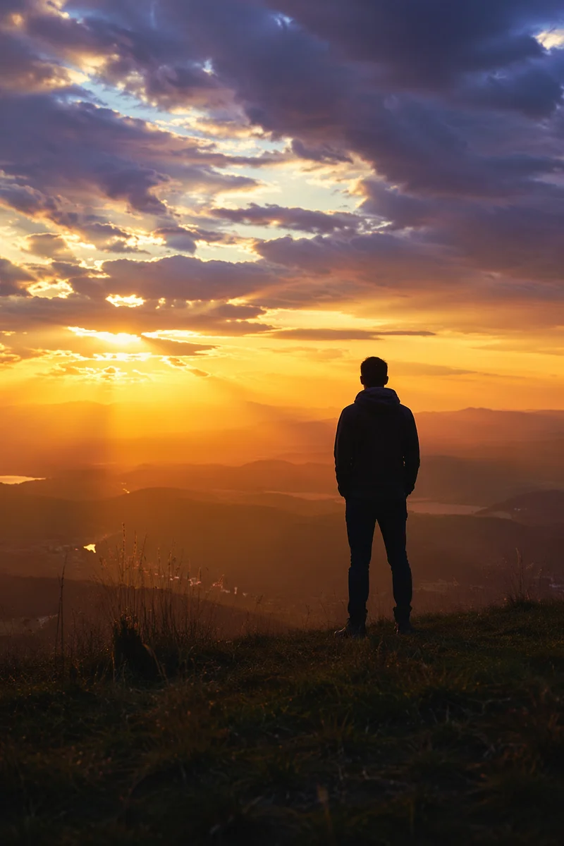 Silhouetted Figure Reflecting on Sunset Ridge