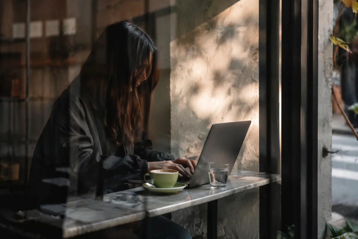 Focused Laptop Work in Cozy Cafe