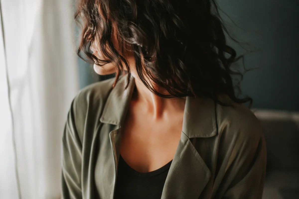 Faceless Confident Woman in Soft Window Light
