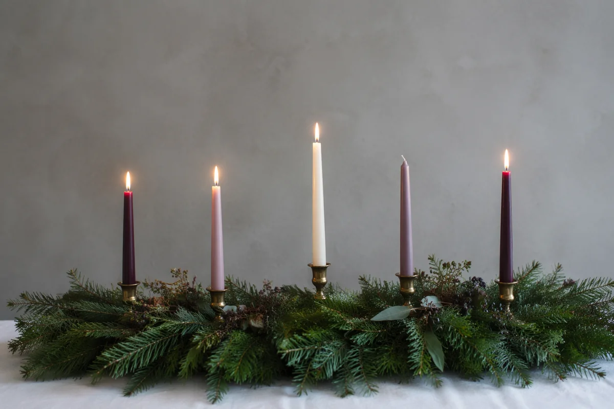 Warm Advent Candles on Evergreen Wreath