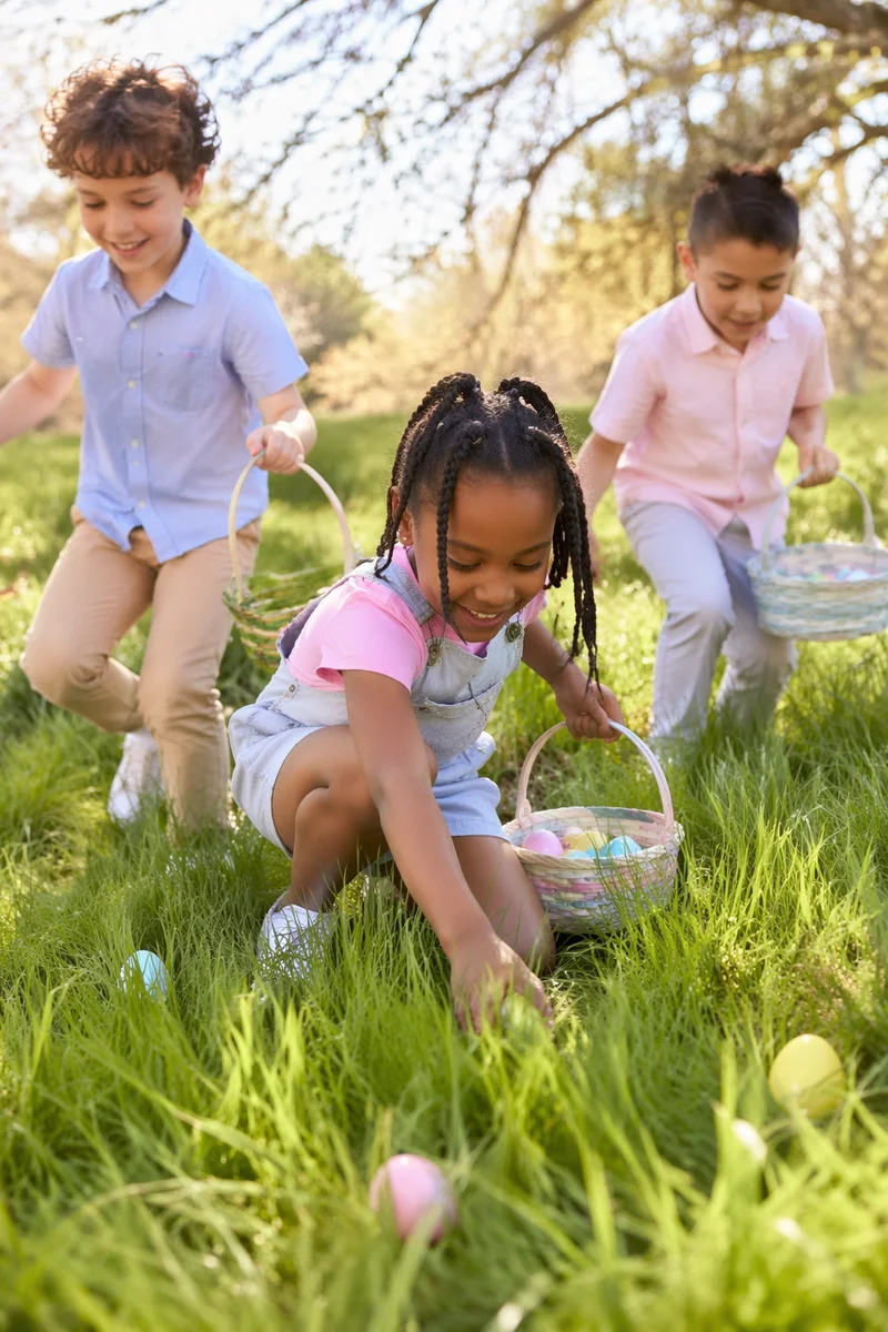 Children Hunting Easter Eggs in Sunny Park