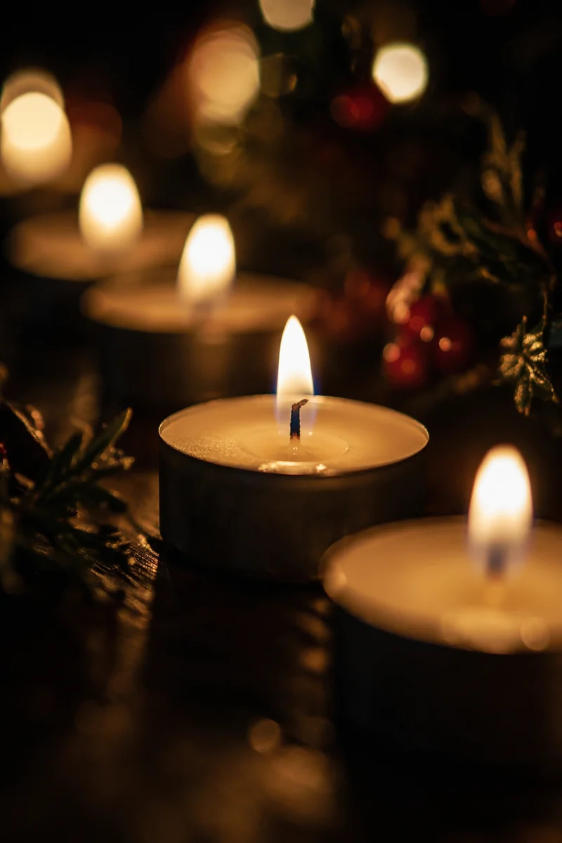 Glowing Tea Light Candles in Darkness