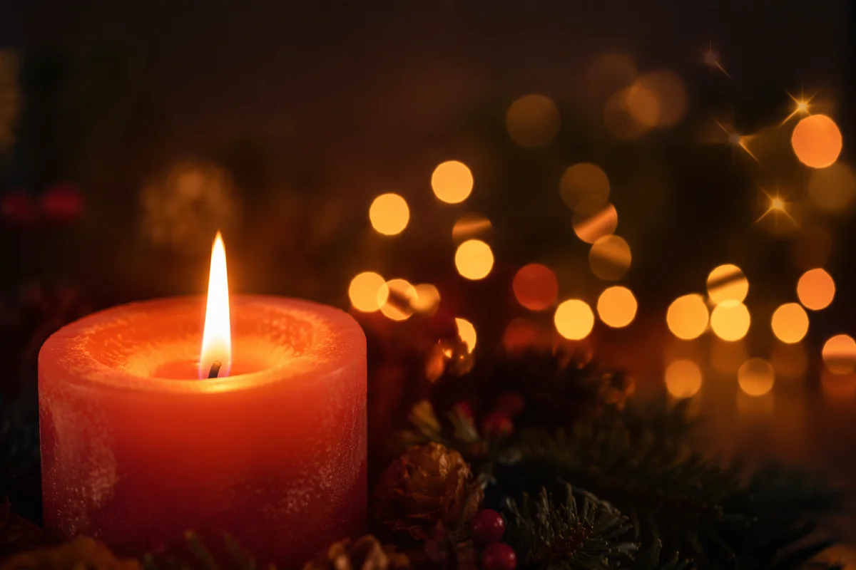 Warm Christmas Candle with Golden Bokeh