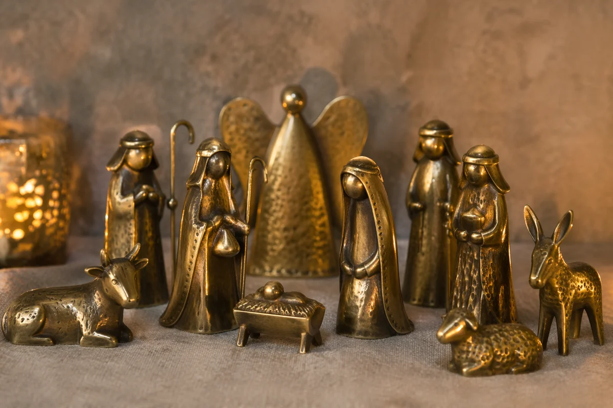 Candlelit Handcrafted Nativity on Soft Gray Fabric
