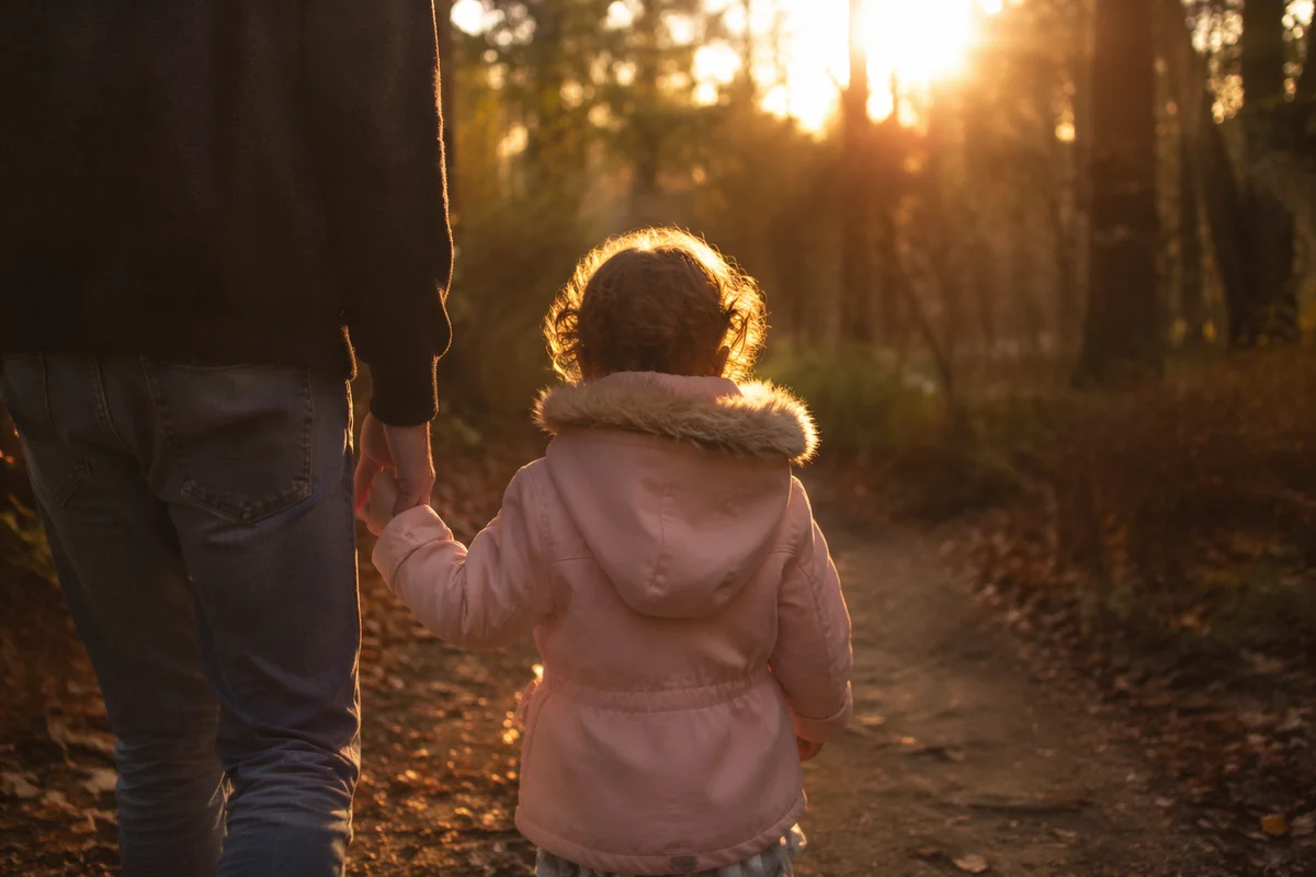 Father and Child on Sunset Woodland Path