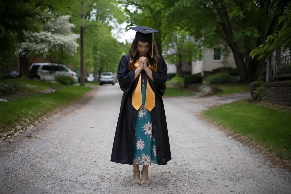 Graduate Praying After Graduation Sunday Service
