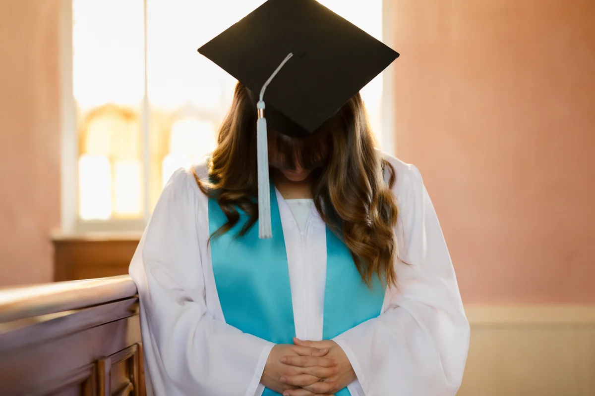 Graduate in Prayer During Sunday Blessing