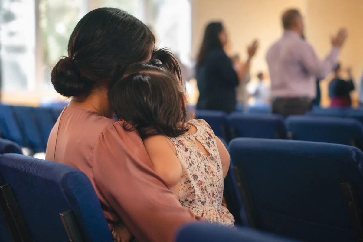 Mother and Child Praying in Soft Light