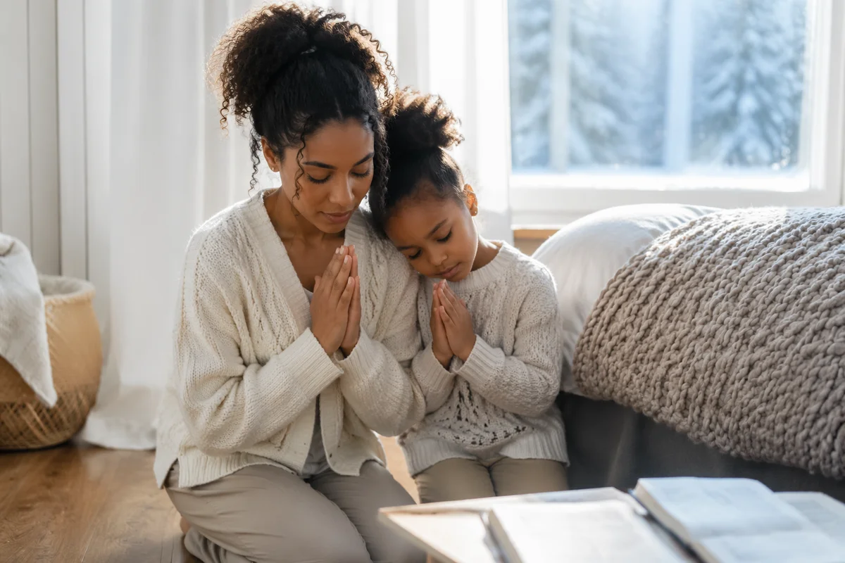 Mother and Daughter Praying by Window