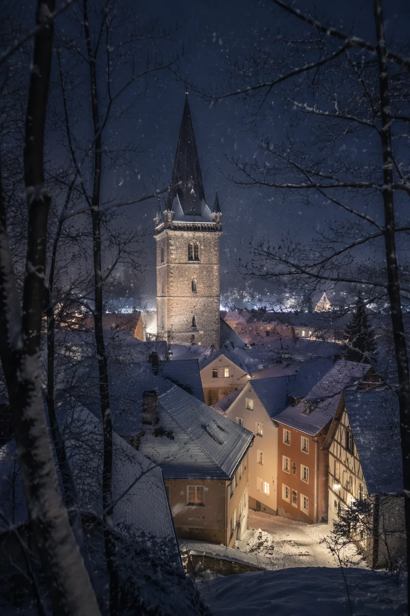 Snowfall Over Church Steeple at Night
