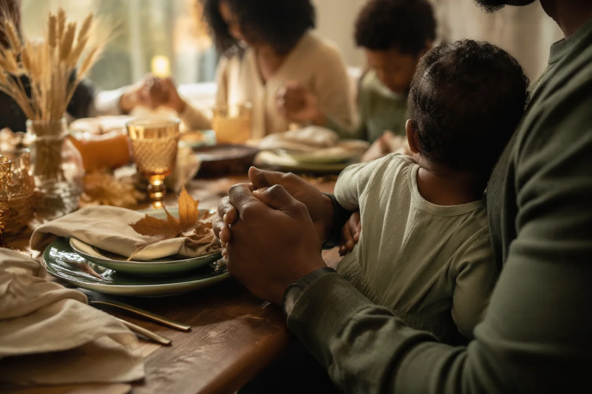 Thanksgiving Family Prayer Around Cozy Dinner Table