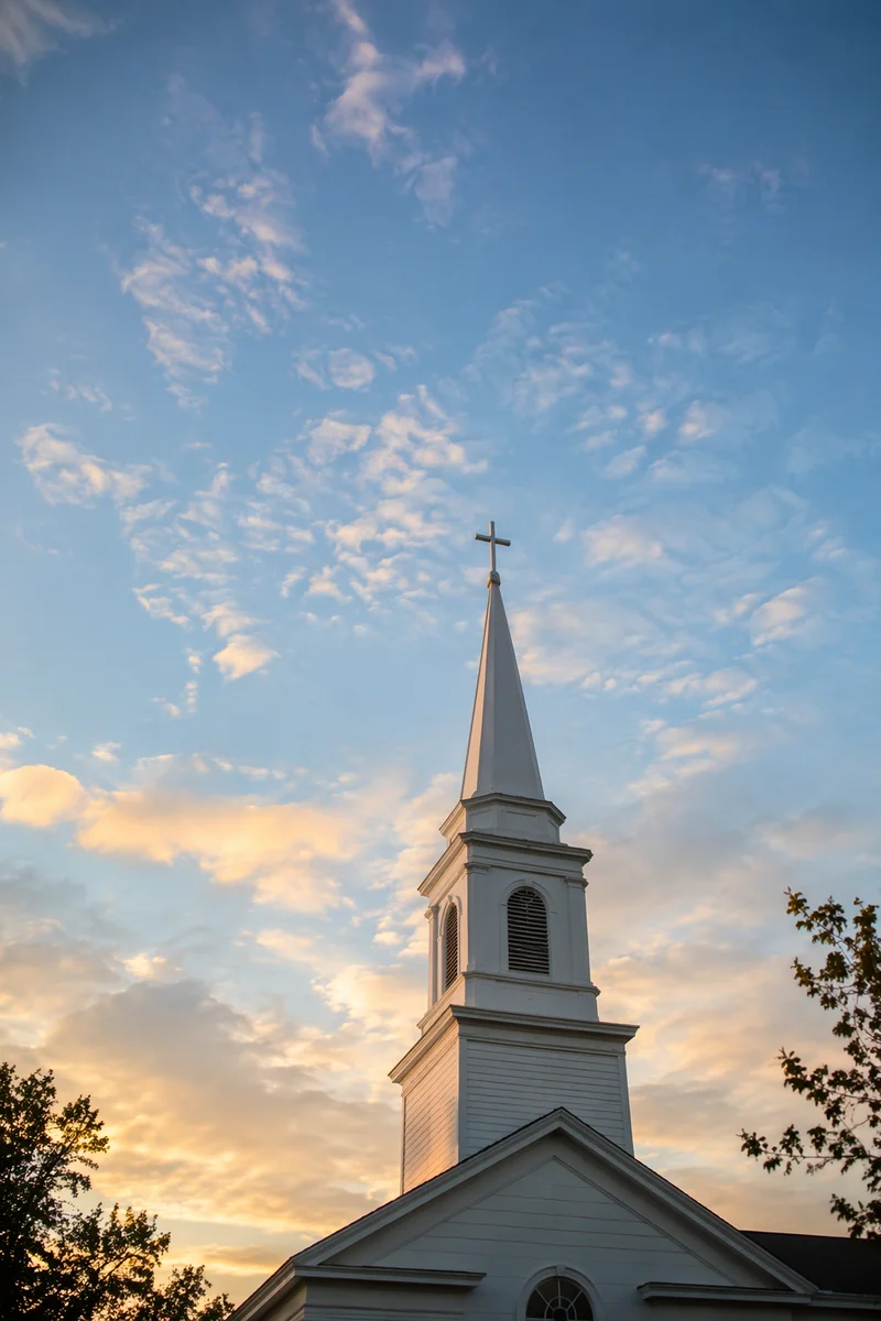 White Church Steeple at Sunrise Sky