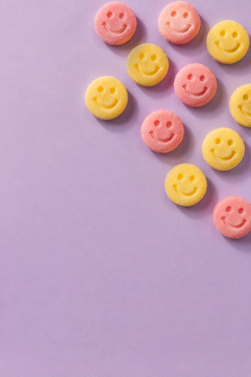 Playful Smiley Candies on Lavender Background