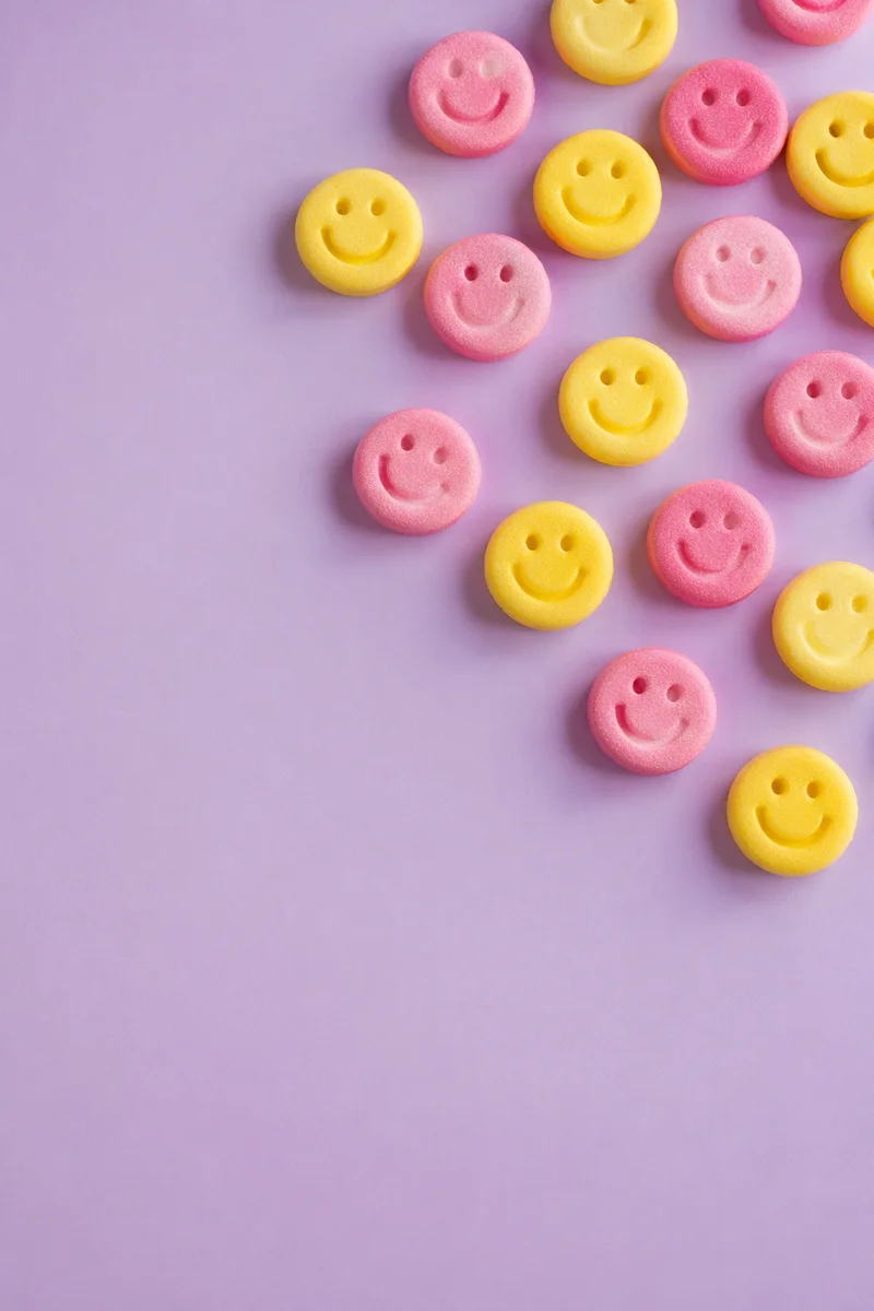 Playful Smiley Candies on Lavender Background