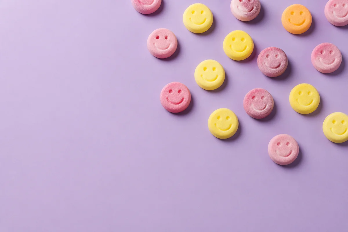 Playful Smiley Candies on Lavender Background