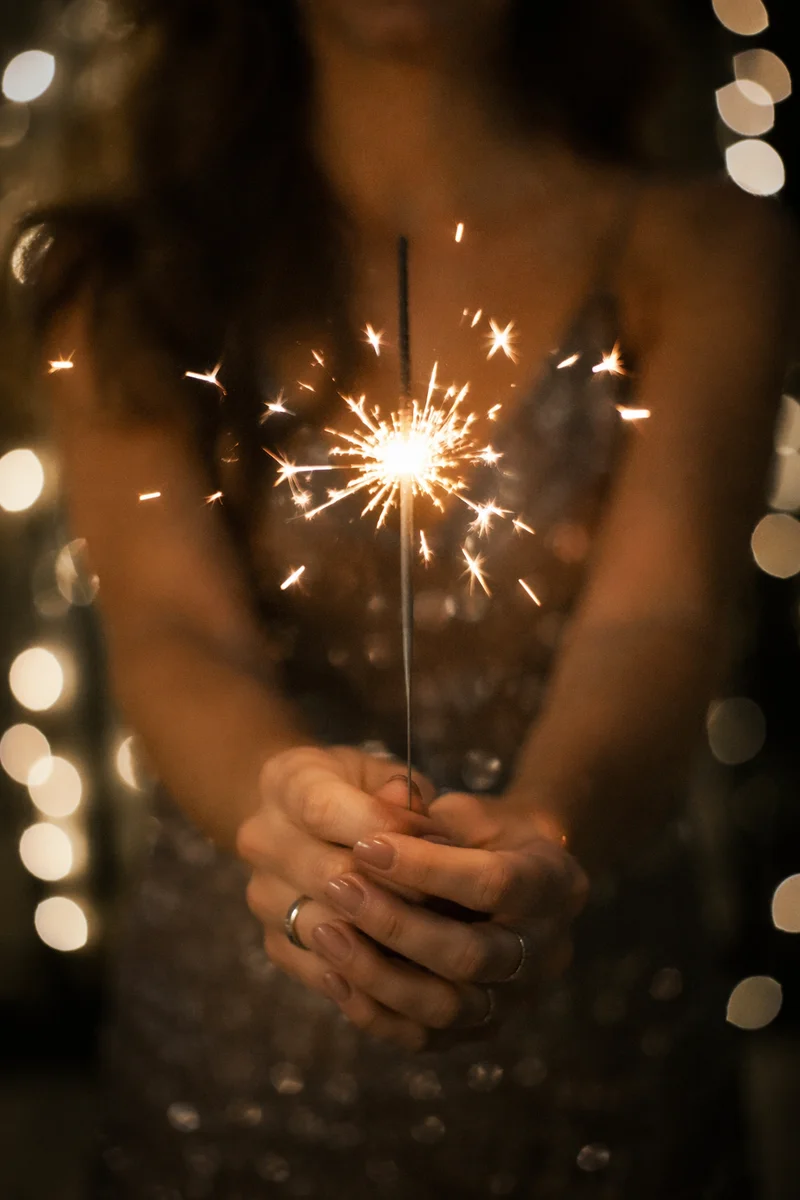 Golden Sparkler Hands at Night Celebration
