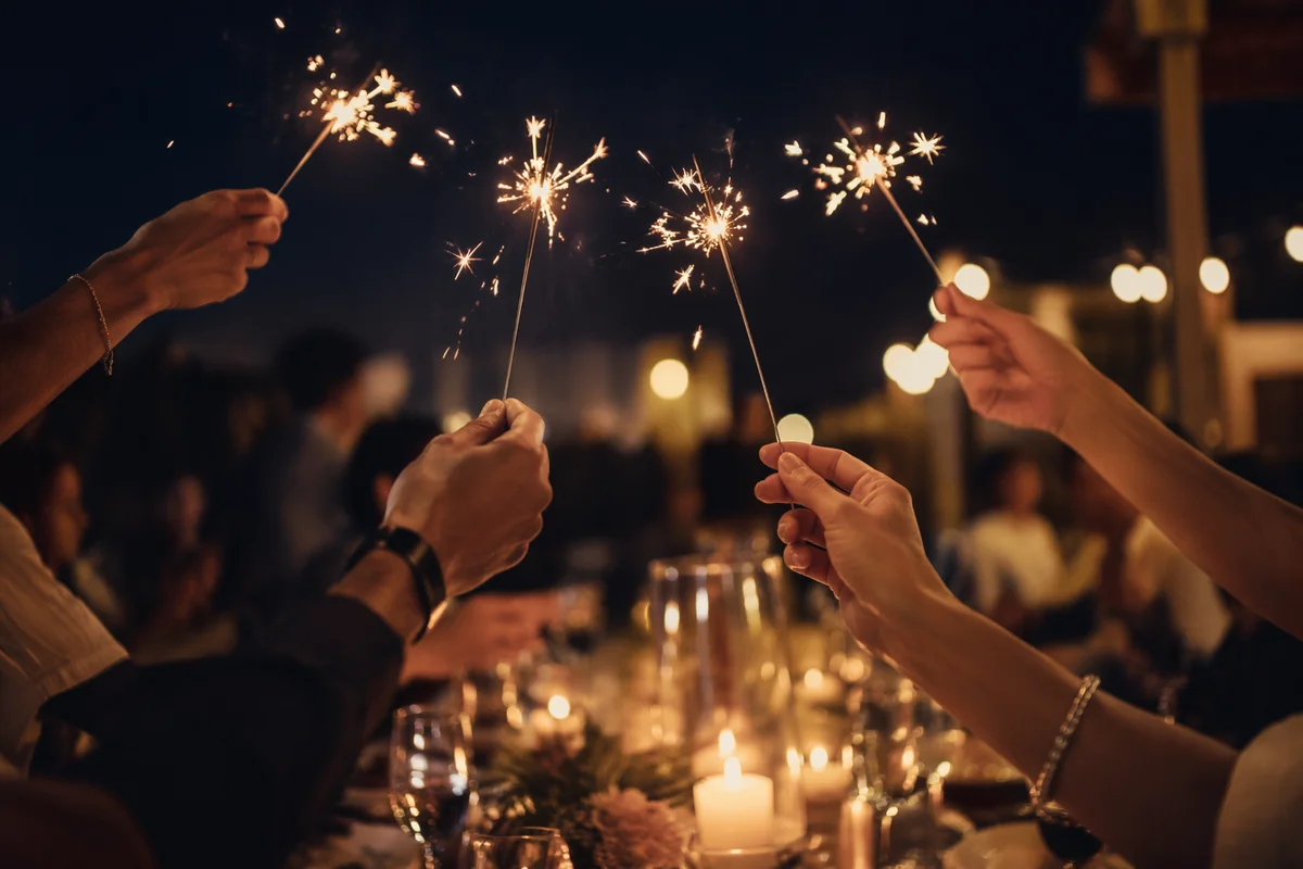 Hands Holding Sparklers at Night Celebration