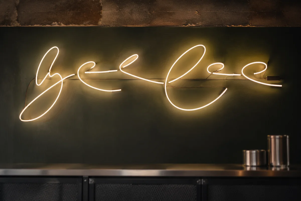 Warm Neon Cursive on Forest Green Wall