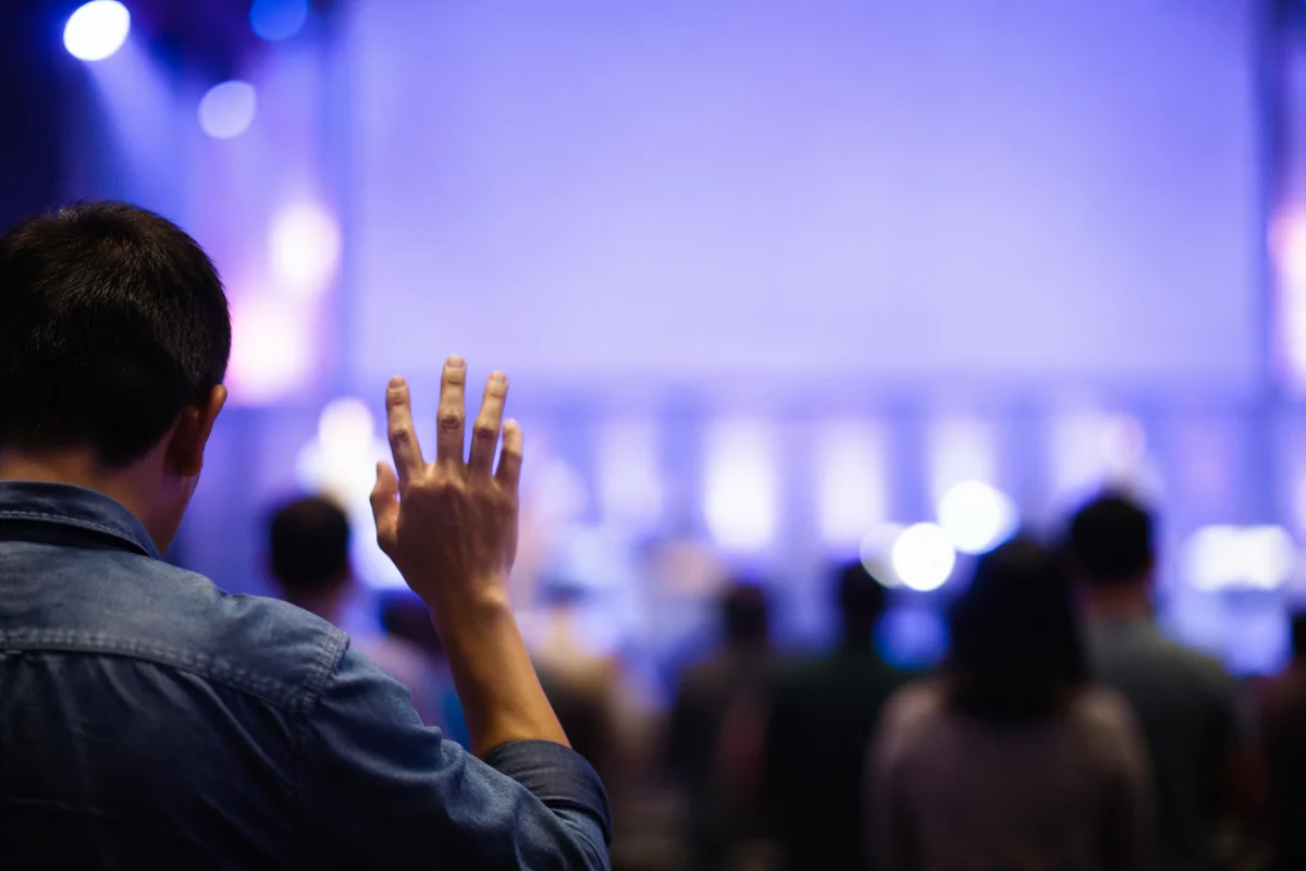 Raised Hand in Worship Hall