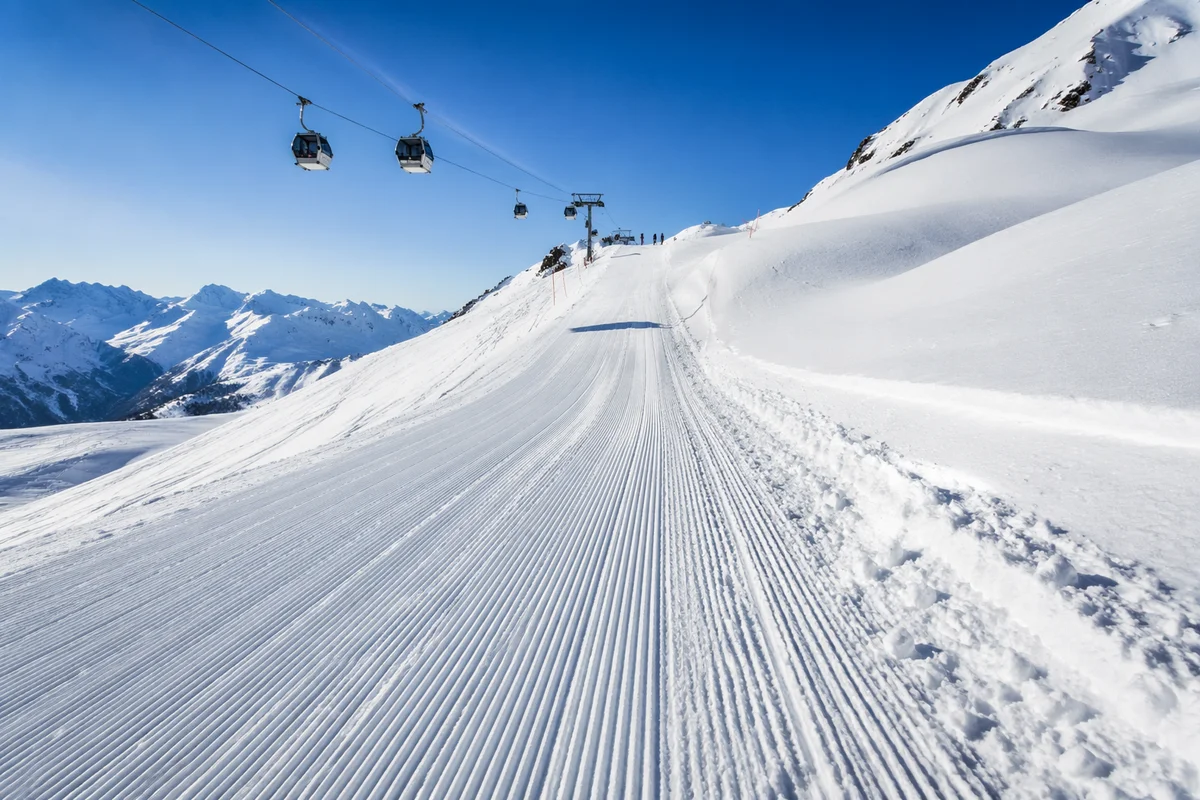 Alpine Downhill Ski Run in Winter Sun