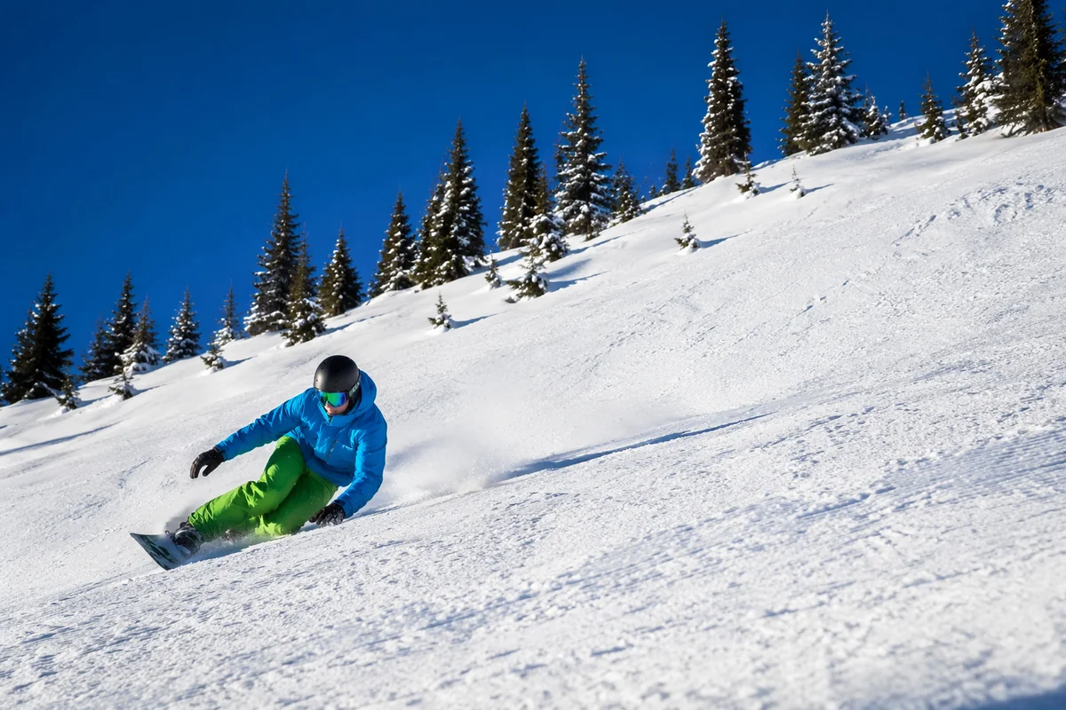 Downhill Skier Carving Fresh Alpine Powder