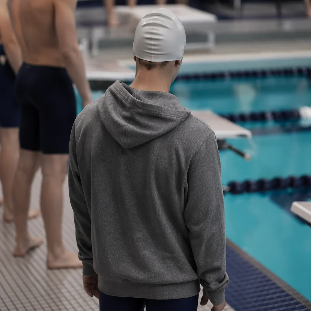 Competitive Swimmer Waiting by Indoor Pool