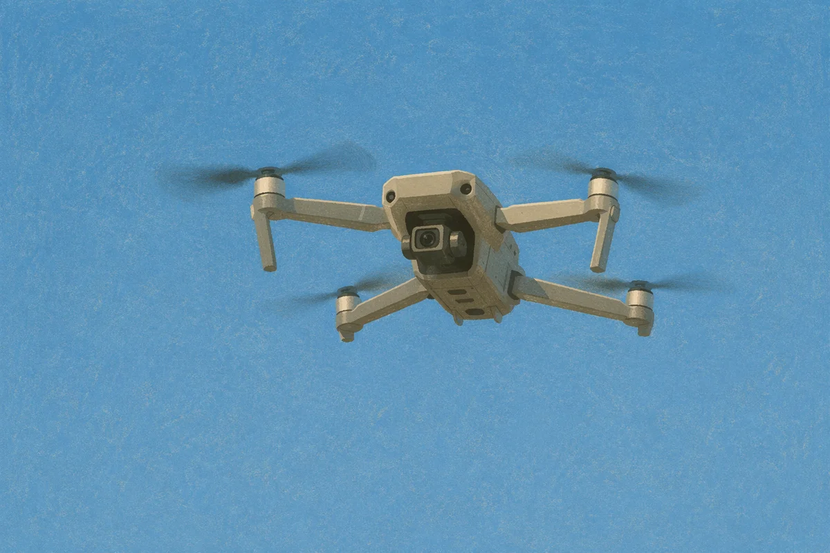 Quadcopter Drone Hovering in Clear Blue Sky