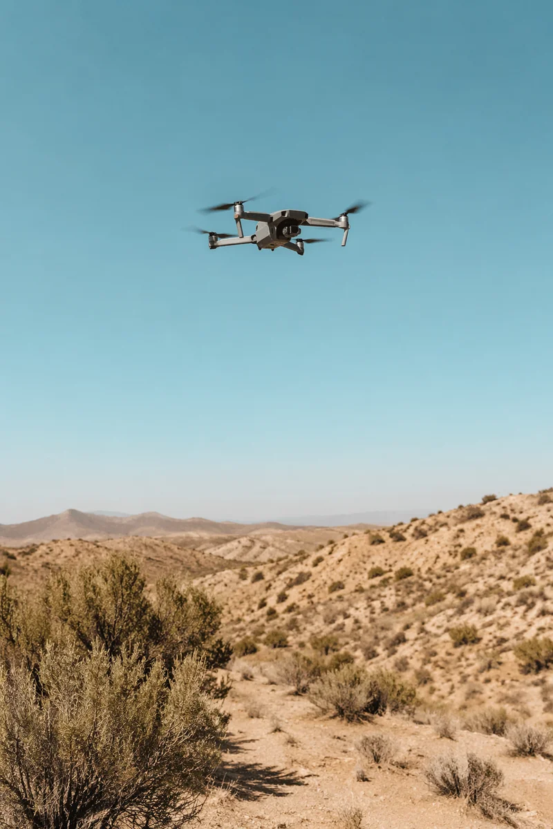 Drone Hovering Above Desert Landscape Sky