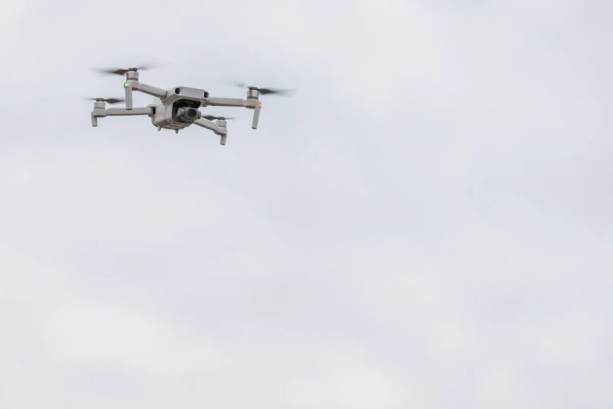 White Quadcopter Drone in Overcast Sky