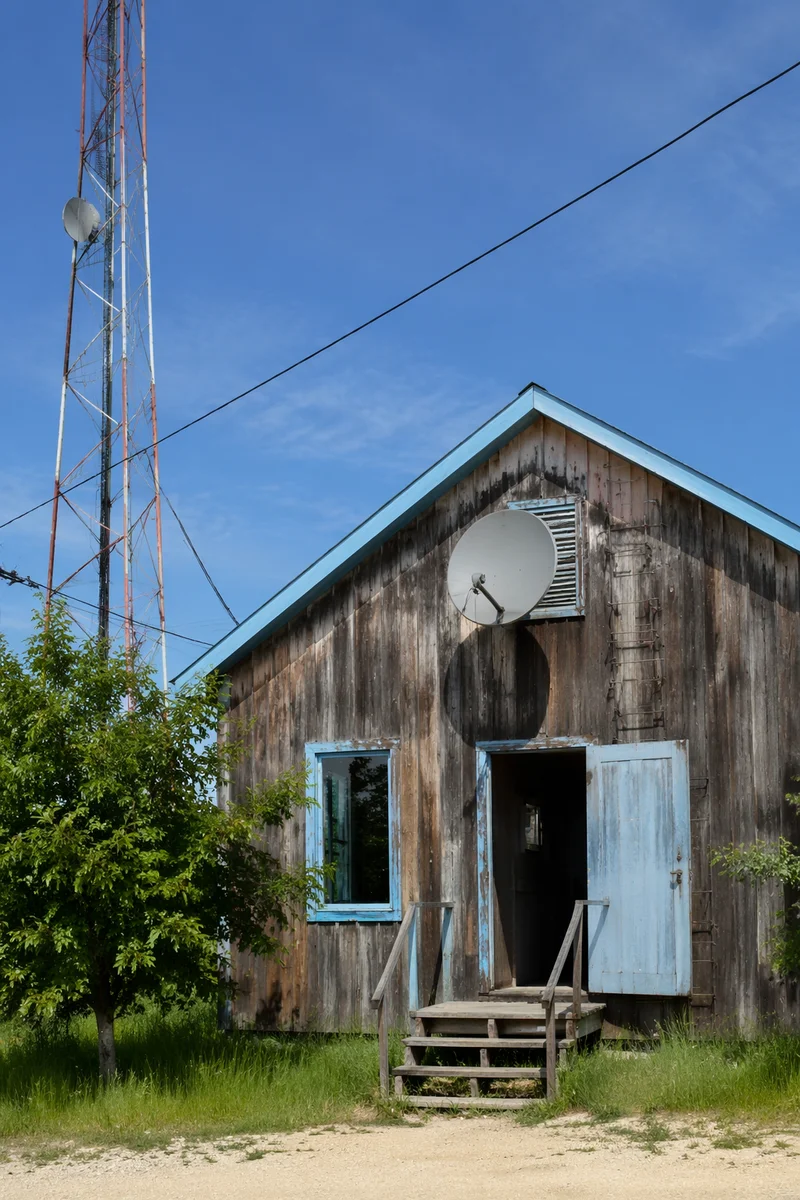 Rural Satellite Dish Under Clear Blue Sky