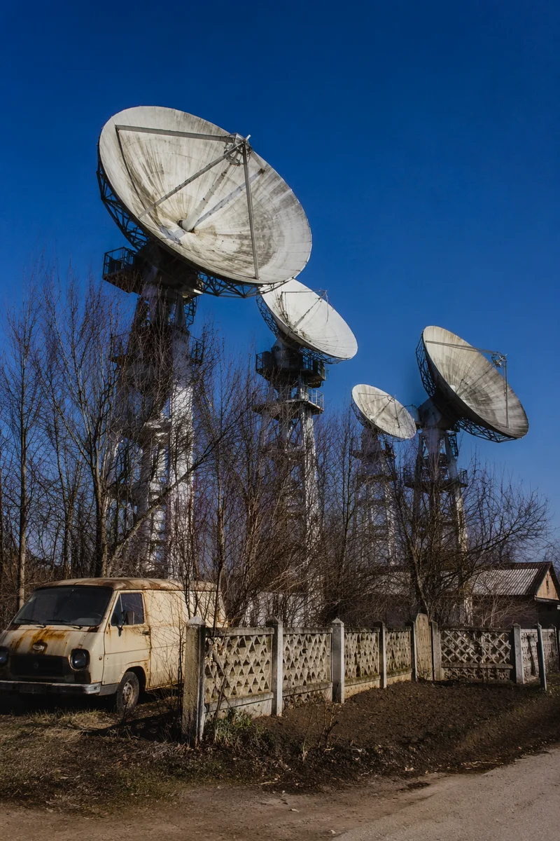 Rural Satellite Dishes Under Clear Blue Sky