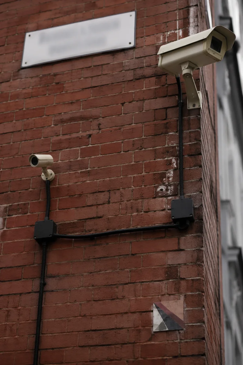Urban Brick Wall Surveillance Cameras