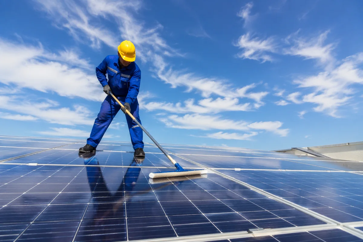 Rooftop Solar Panel Maintenance Under Bright Sky