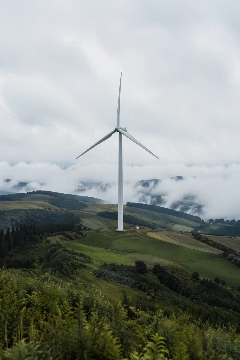 Wind Turbine Over Misty Green Hills
