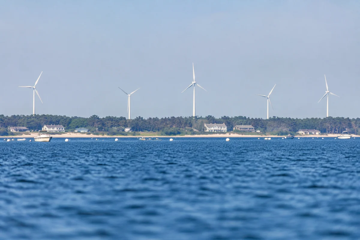 Coastal Wind Turbines Over Calm Blue Water