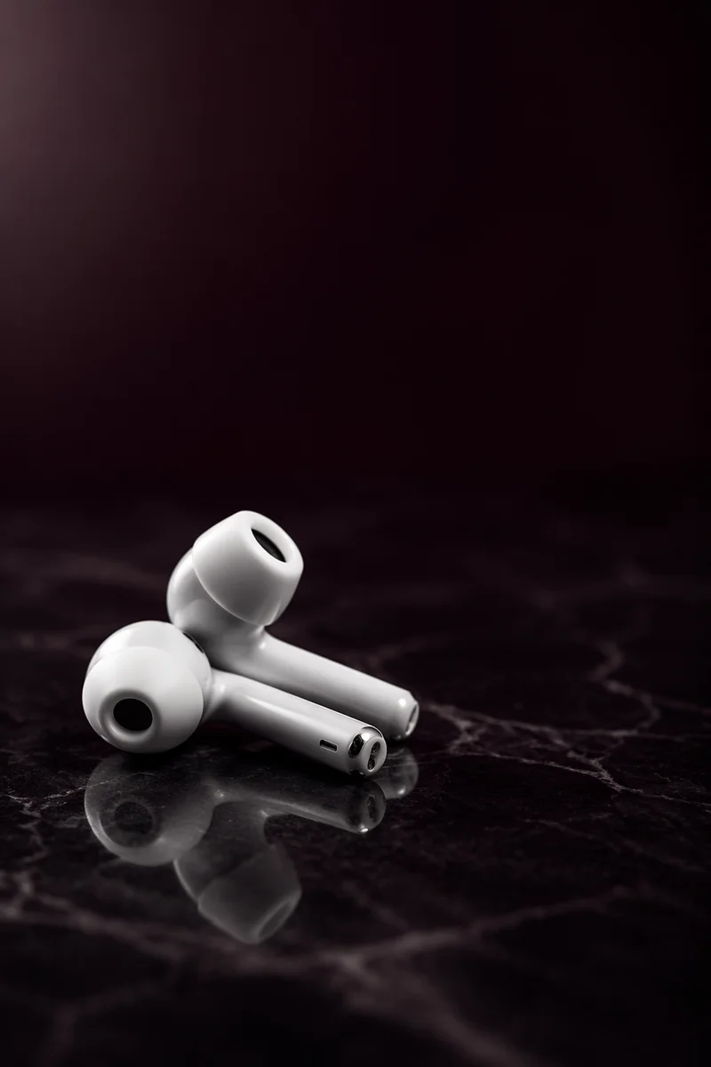 Minimal White Earbuds on Dark Marble
