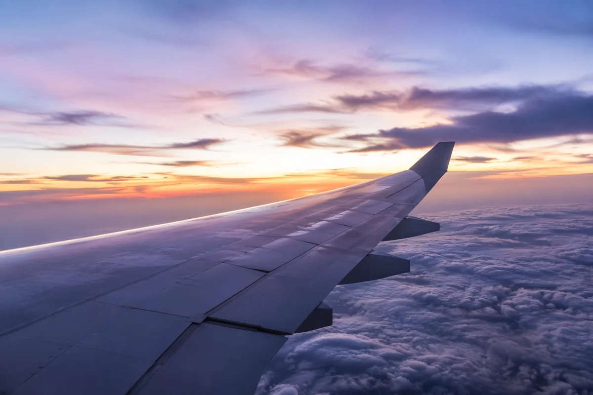 Peaceful Airplane Wing Above Twilight Clouds