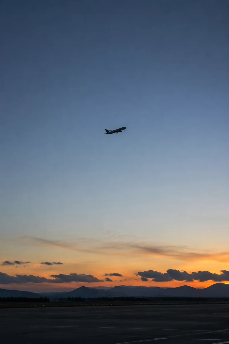 Airplane Taking Off Into Blue Dawn Sky