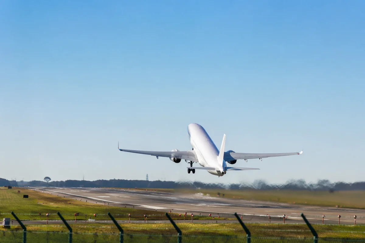 Passenger Airplane Taking Off Under Blue Sky