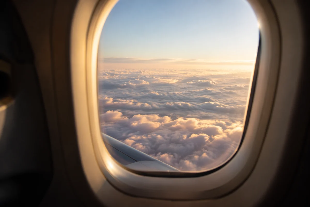Serene Airplane Window View Above Clouds