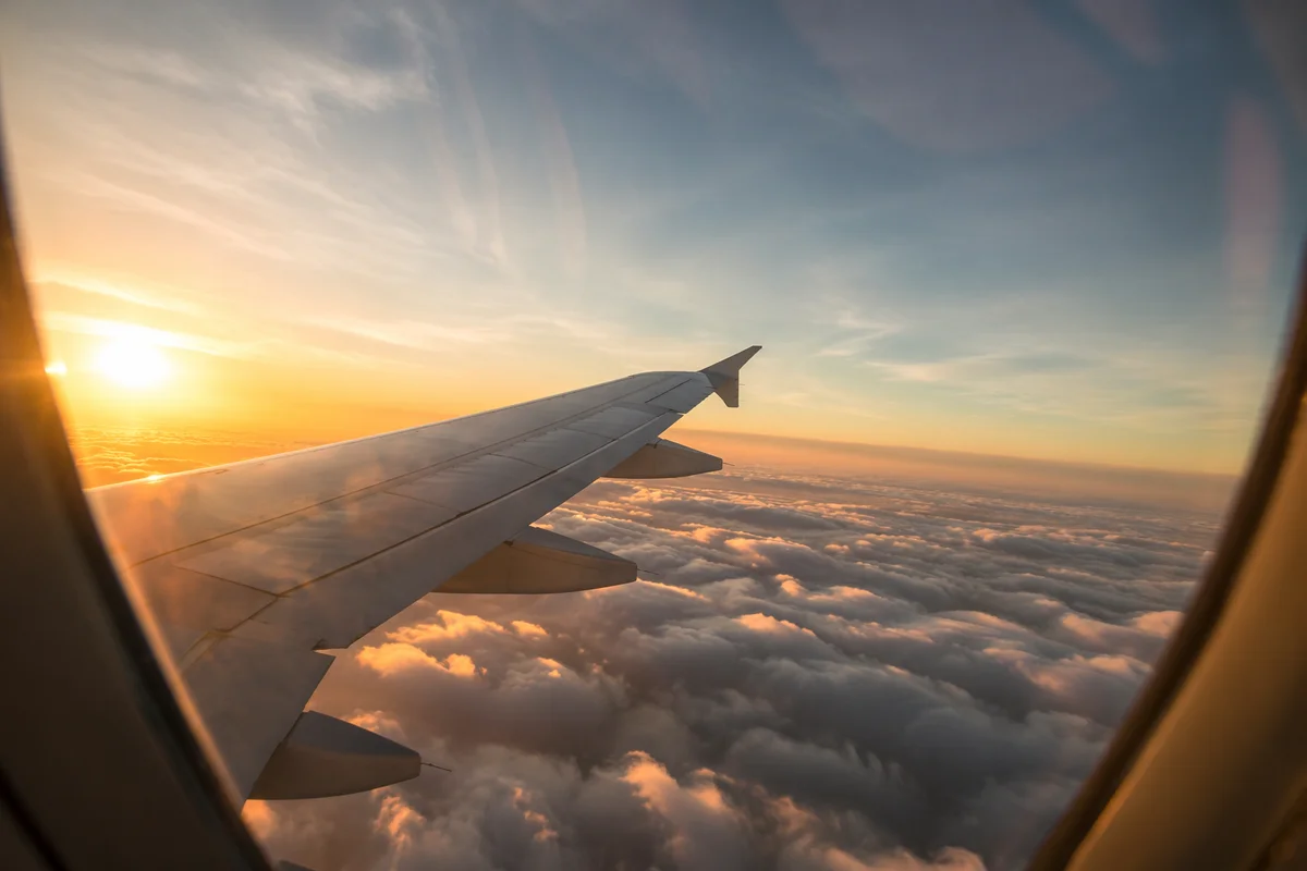 Sunset Airplane Window View Above Clouds