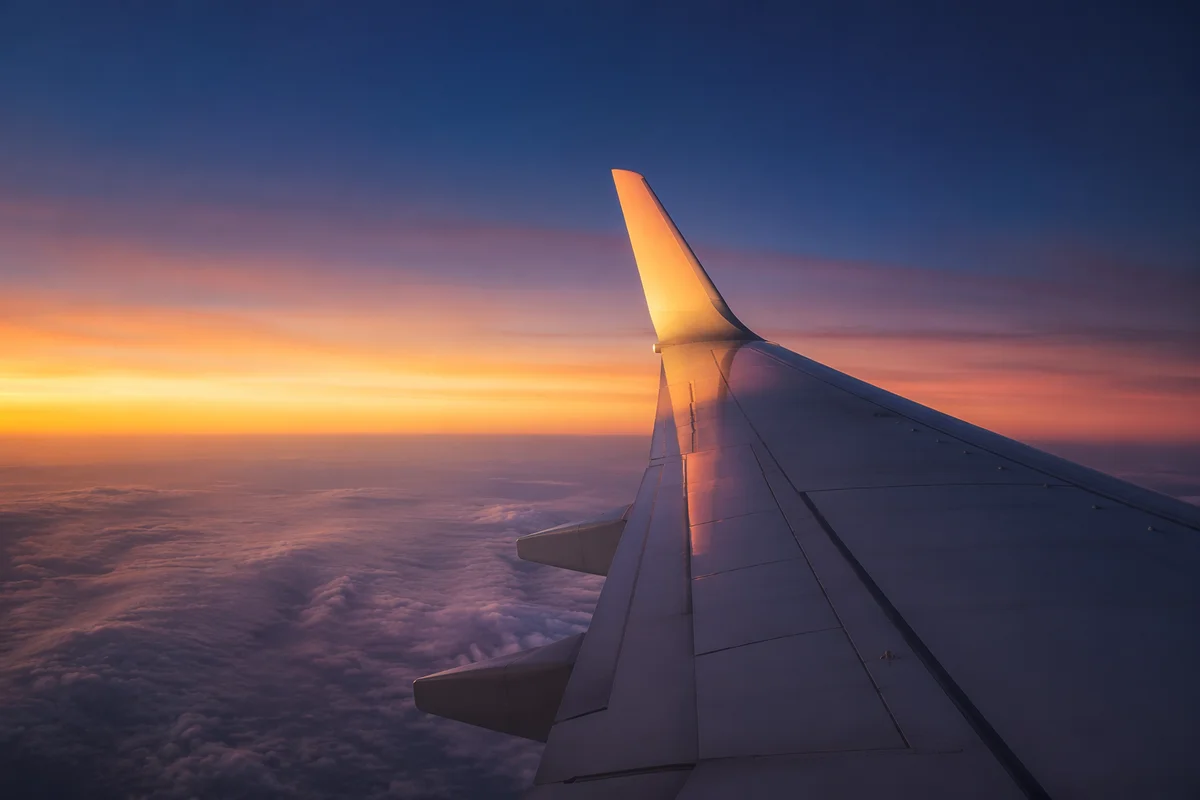 Sunrise Airplane Wing Above Soft Clouds