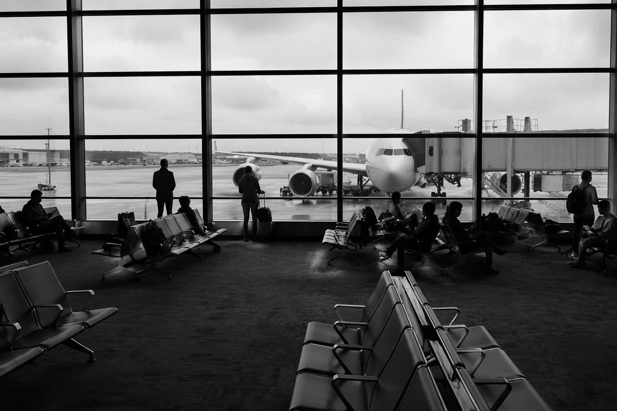 Quiet Airport Departure Gate With Travelers