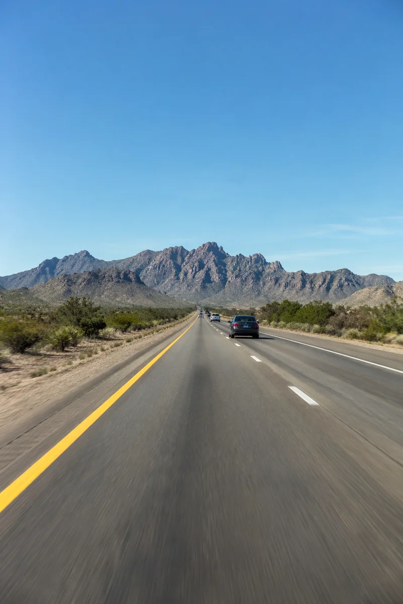 Desert Highway Road Trip Toward Mountains
