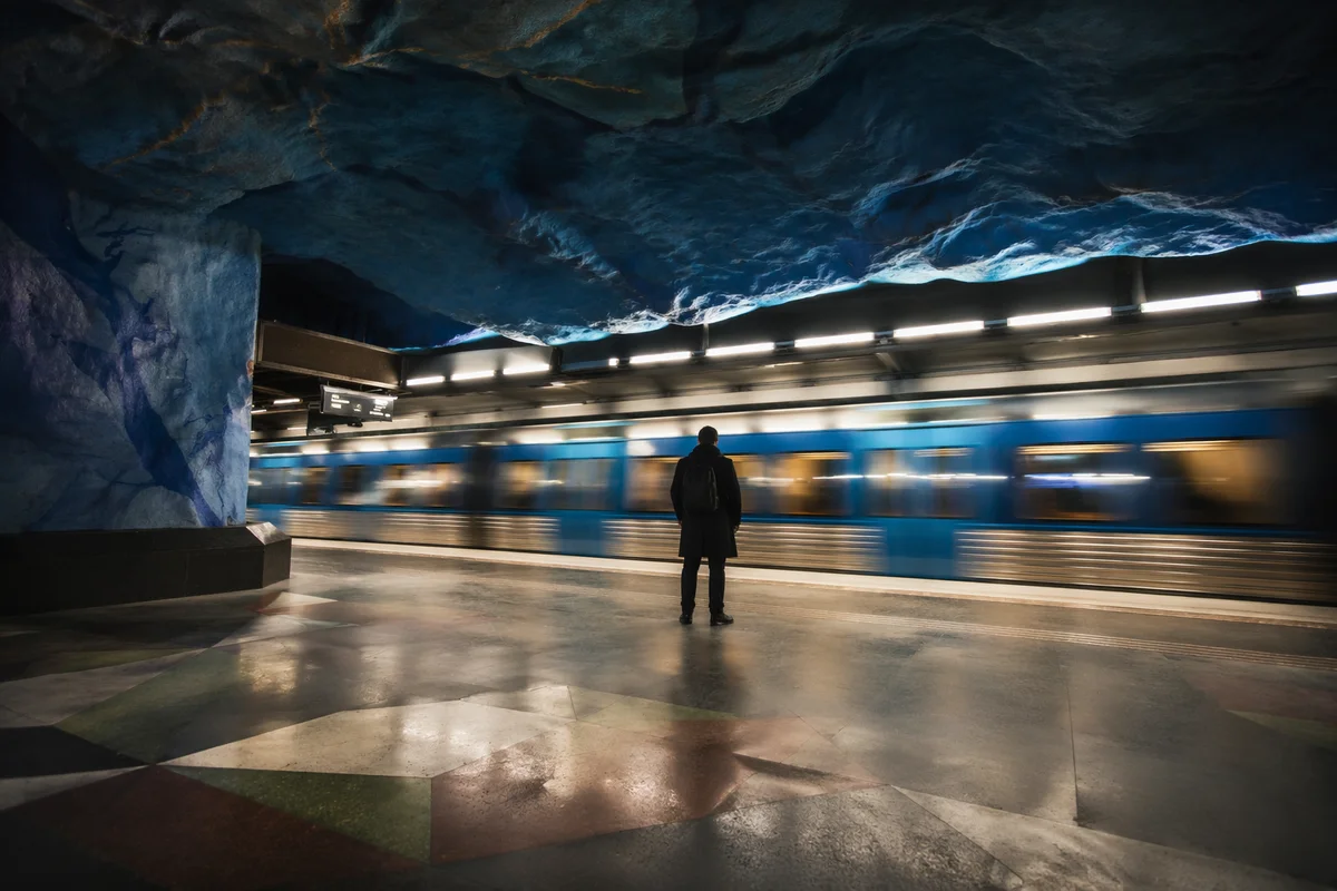 Solitary Commuter on Cave-Like Metro Platform